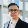 Professional man in glasses and blazer, representing Block 24 Marketing, emphasizing digital marketing expertise and leadership.