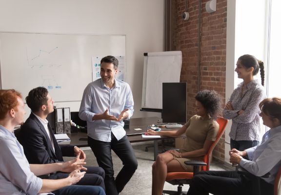 Group of diverse professionals engaged in a collaborative discussion, with a focus on building a supportive and empathetic environment, relevant to mental health and counseling services.