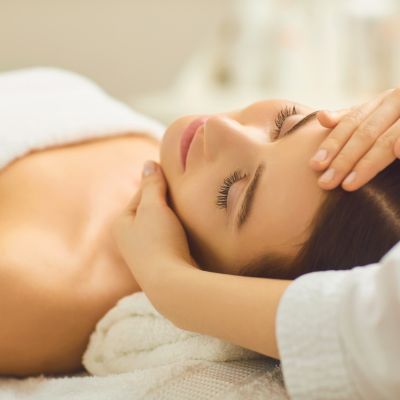 Woman receiving a facial treatment at a medical spa, emphasizing relaxation and beauty care, relevant to marketing strategies for aesthetic services.