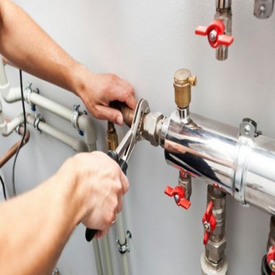 Hands using a wrench to tighten plumbing pipes, illustrating home services expertise for local visibility and lead generation in plumbing and HVAC industries.