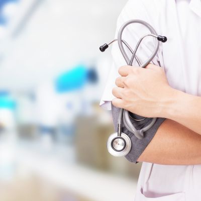 Healthcare professional with a stethoscope in a clinical setting, symbolizing patient-focused care and trust in healthcare marketing strategies.